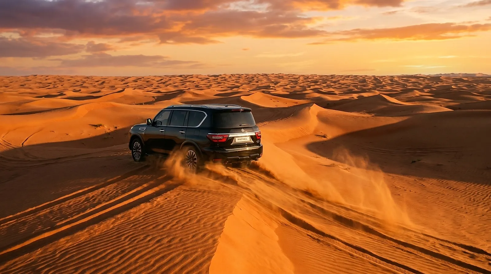 Black Nissan Patrol driving over the dunes of Wahiba Sands at sunset